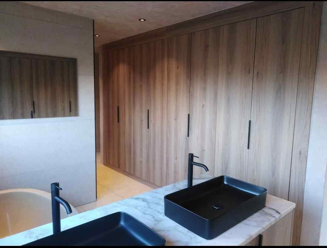 "Warm wood tones + bold black finishes. Clean lines, calm spaces.