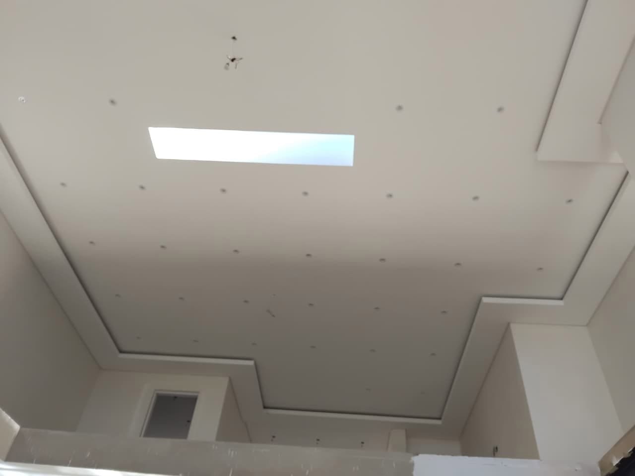 Multi-level bulkhead ceiling with recessed lighting and a skylight — clean lines that lift the whole room up. ☀️